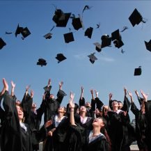 Students celebrating graduation by throwing their academic hats in the air