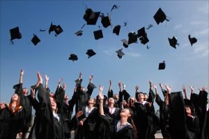Students celebrating graduation by throwing their academic hats in the air