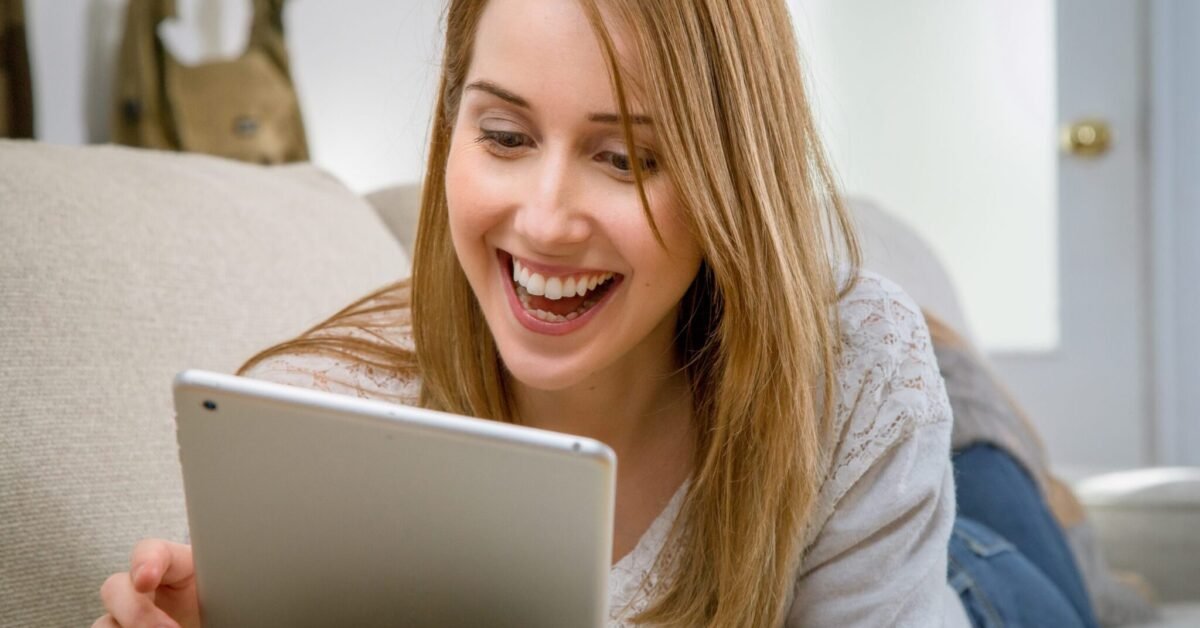 A young lady holding a tablet