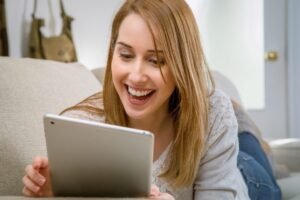 A young lady holding a tablet