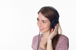 A young lady with headphones on